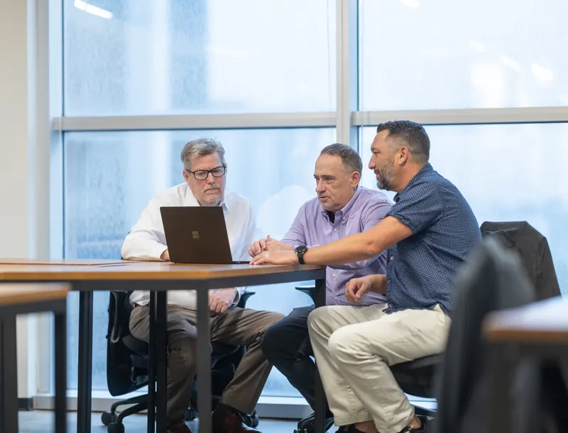 Three of the team at the window table