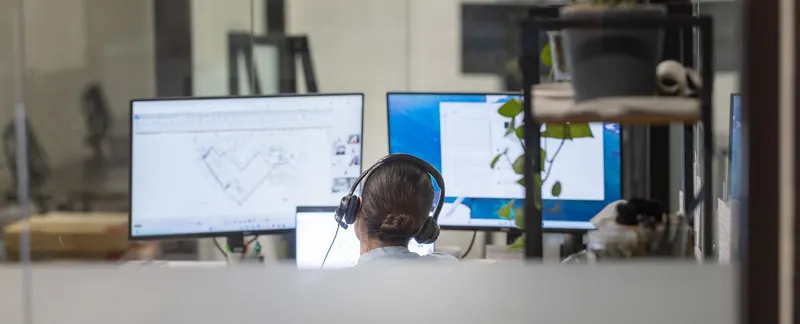 On a headset at a desk