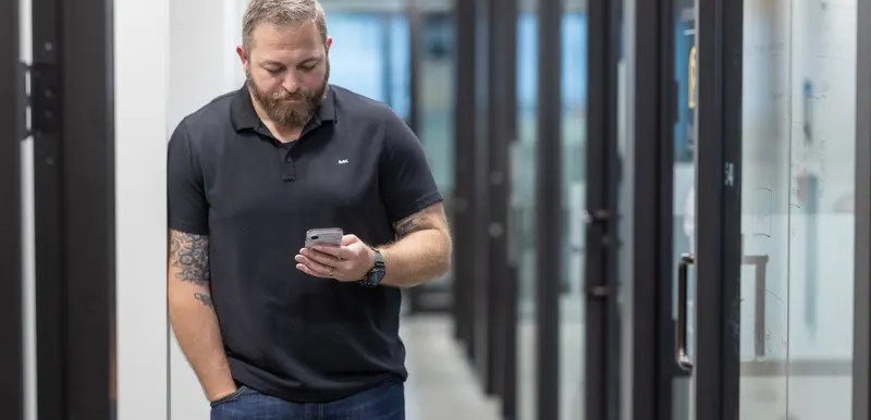 In the corridor, phone in hand