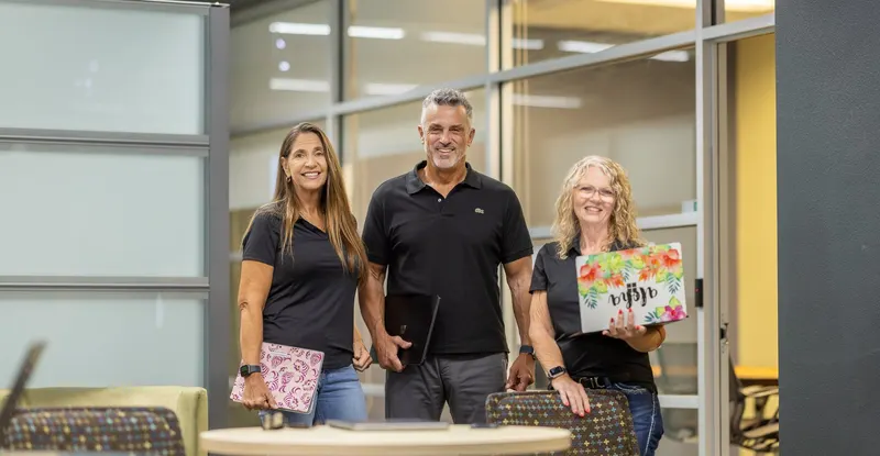 Three of the team in the main office